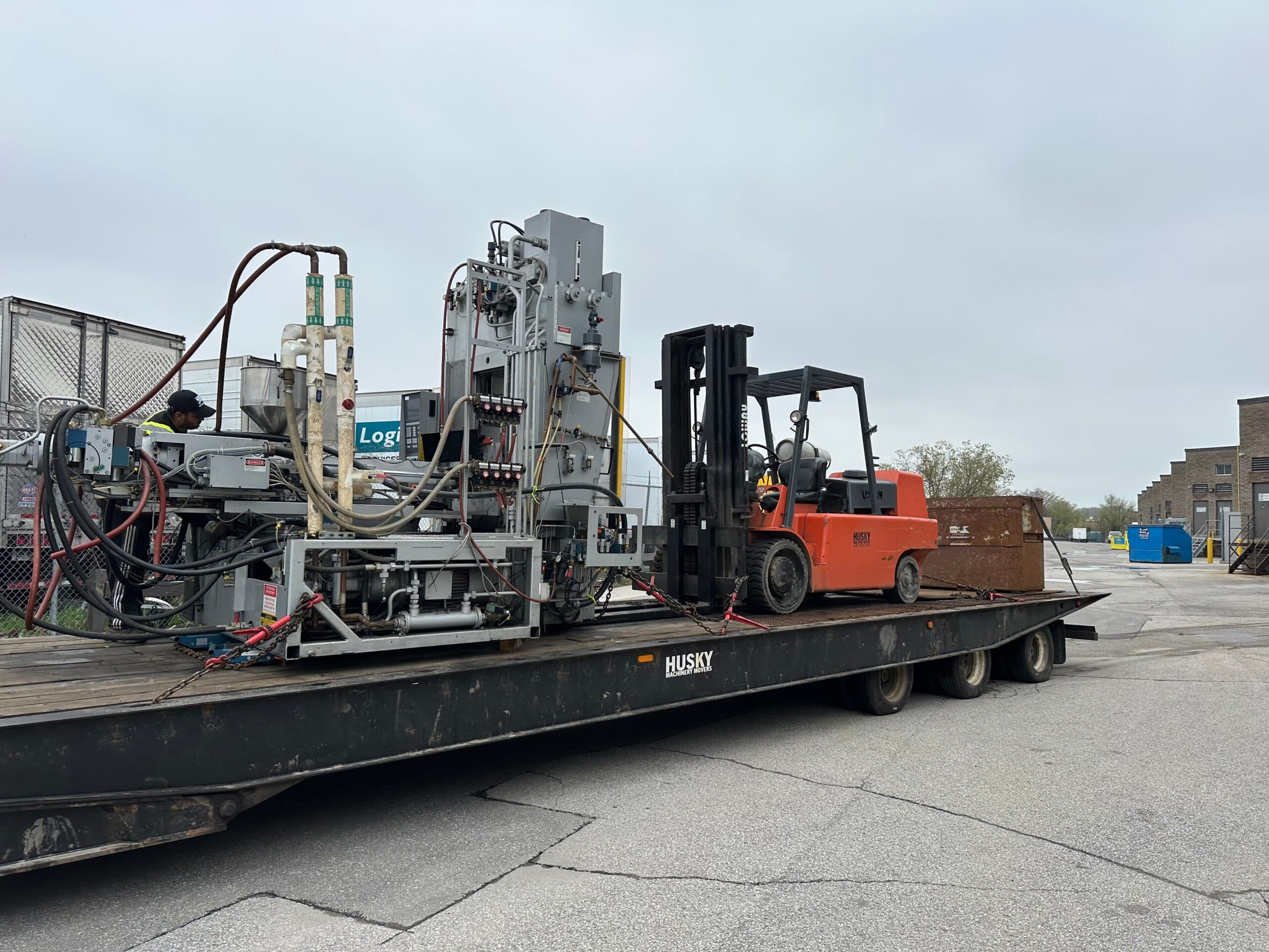 Professional machinery movers relocating heavy industrial CNC equipment in Ontario manufacturing facility - Husky Machinery Movers